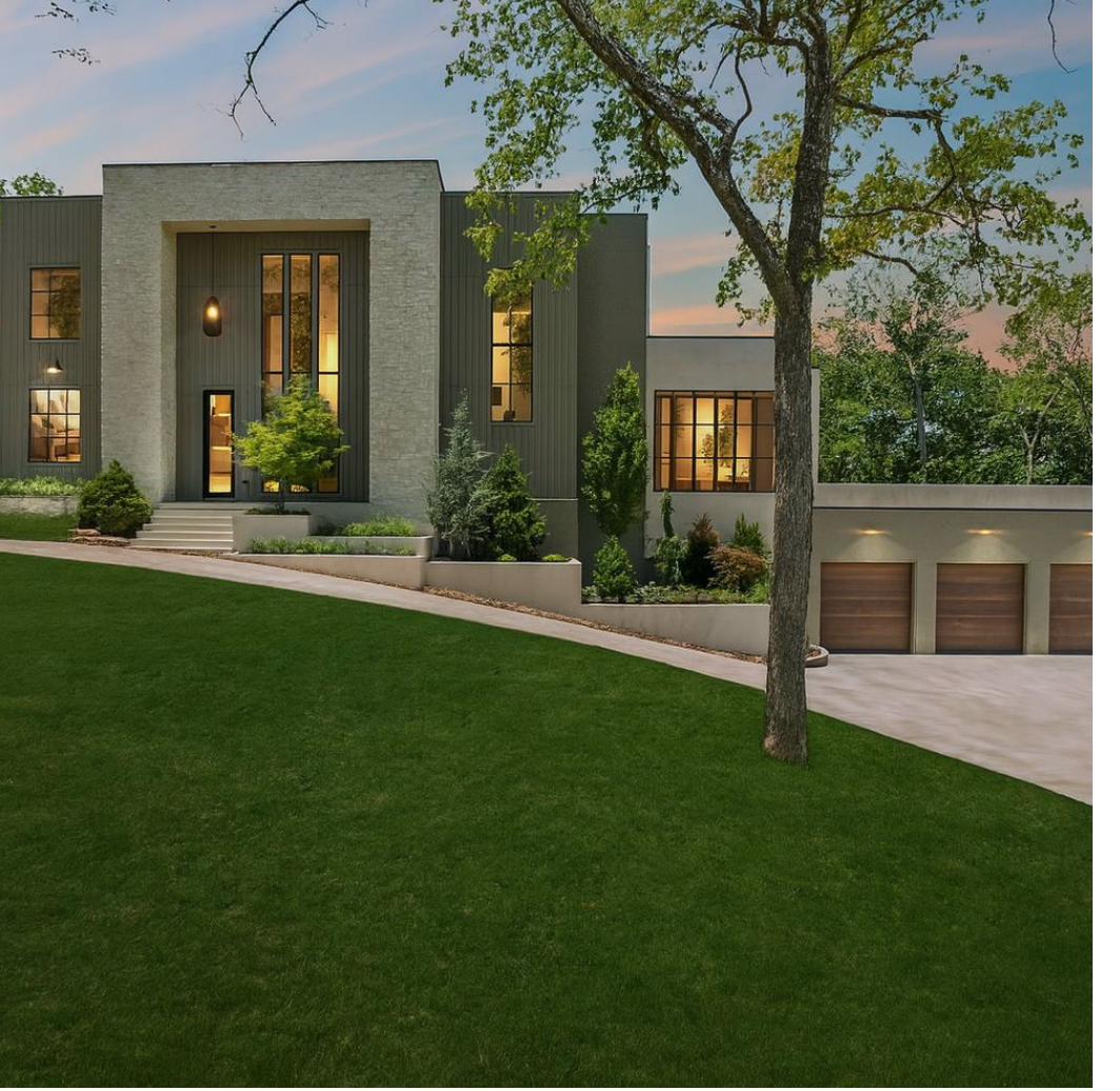 Modern Nashville home with Japanese maple and evergreen planting design at dusk